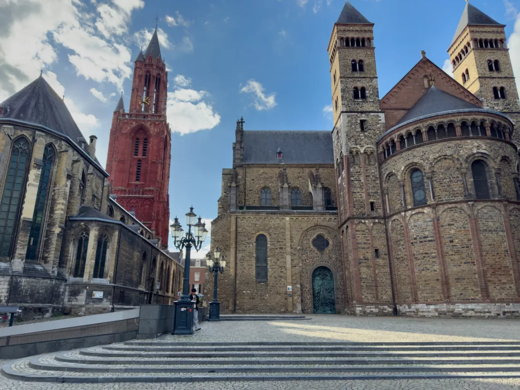 Vrijthof in Maastricht with the red tower of St John's Church and the Romanesque Basilica of St Servatius beside it.